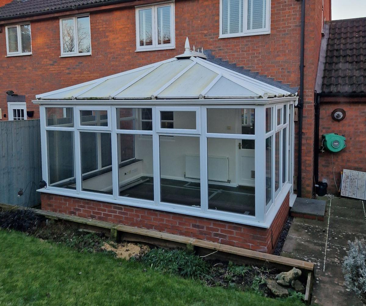 Before: polycarbonate roof replaced with a tiled roof in Pewter Grey