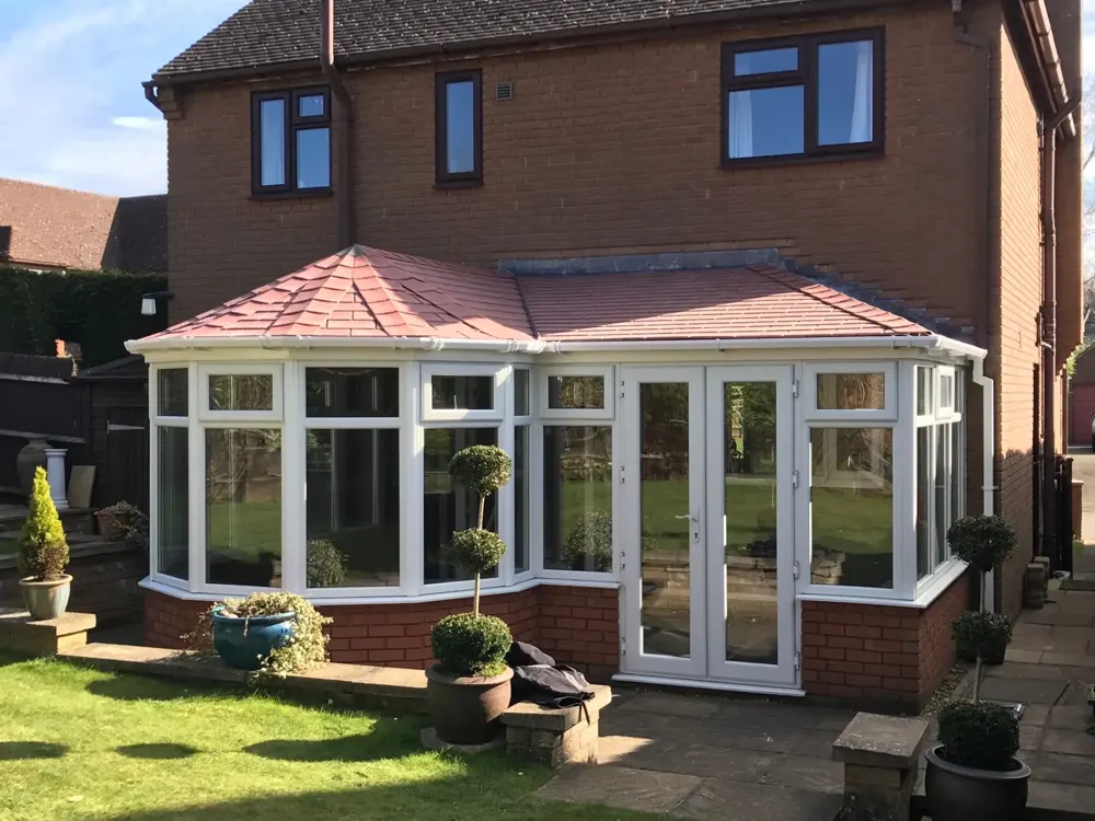P-shape conservatory with a tiled roof fitted by Nu-Look