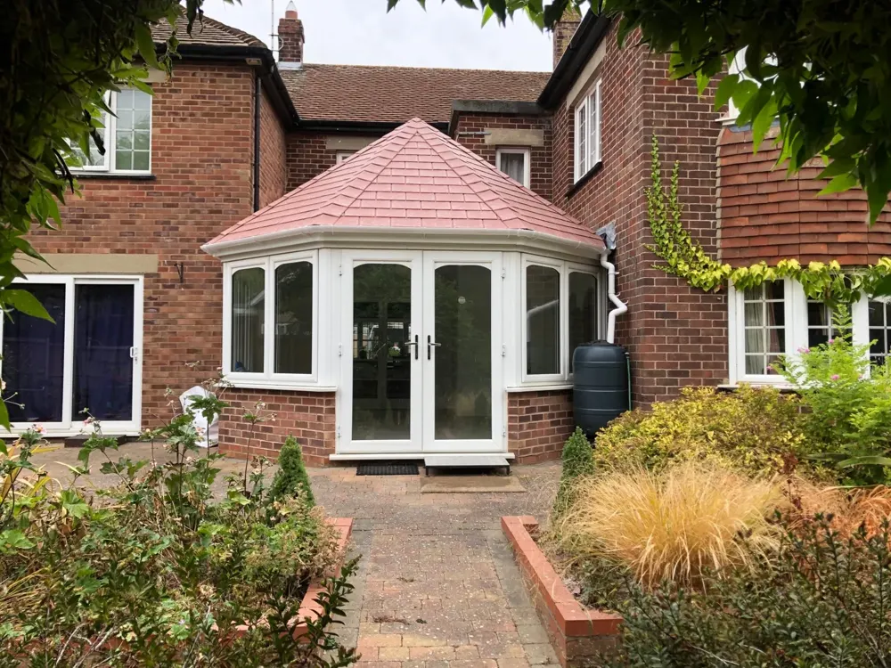 three-part Victorian conservatory with a tiled roof fitted by Nu-Look