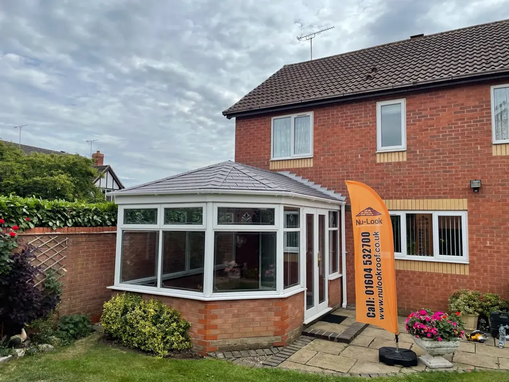 three-part Victorian conservatory with a tiled roof fitted by Nu-Look