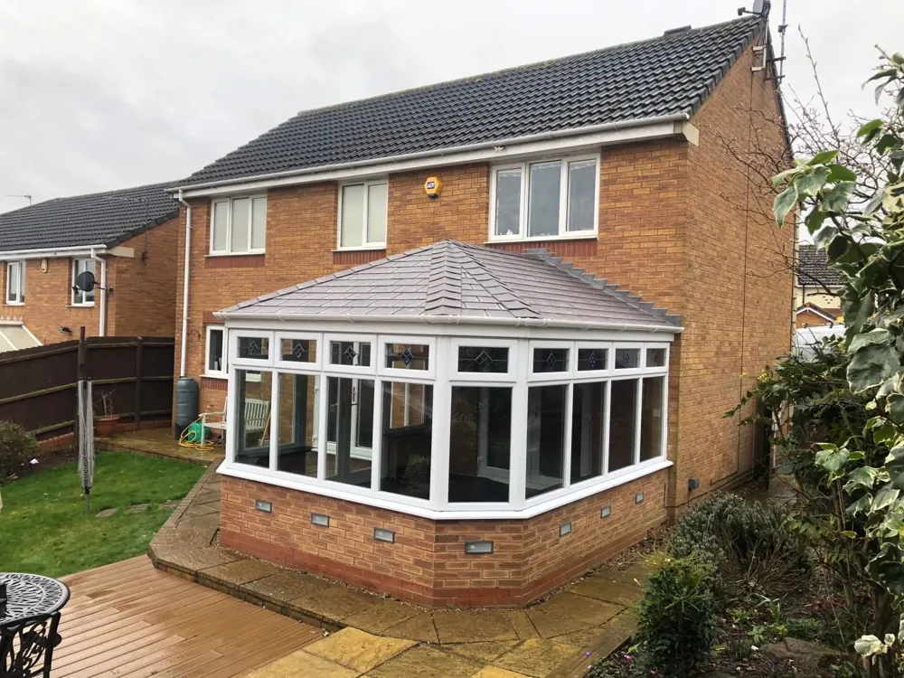 Victorian three-part conservatory with a slate-effect tiled roof fitted by Nu-Look